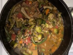 Photograph of a pot of lamb and roasted vegetable stew