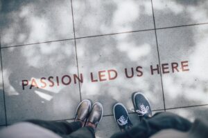 Words on a sidewalk stating, "Passion led us here."