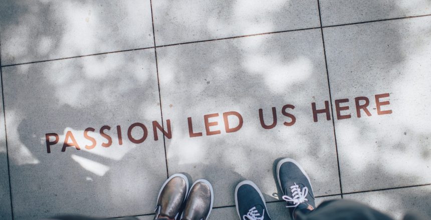 Words on a sidewalk stating, "Passion led us here."